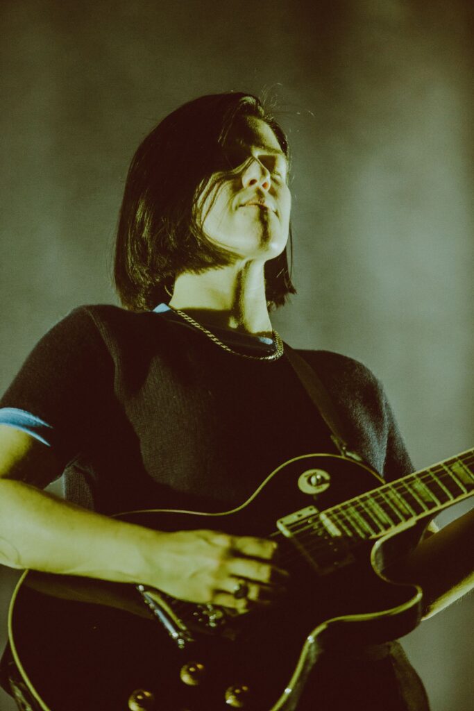 Image may contain Person Guitar Guitarist Leisure Activities Music Musical Instrument Musician Performer and Face